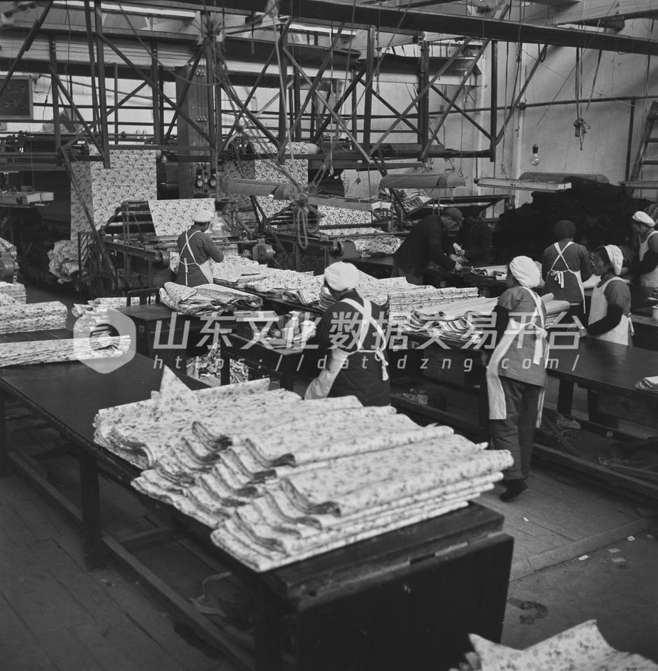 青岛印染厂工人正在检查布匹质量。